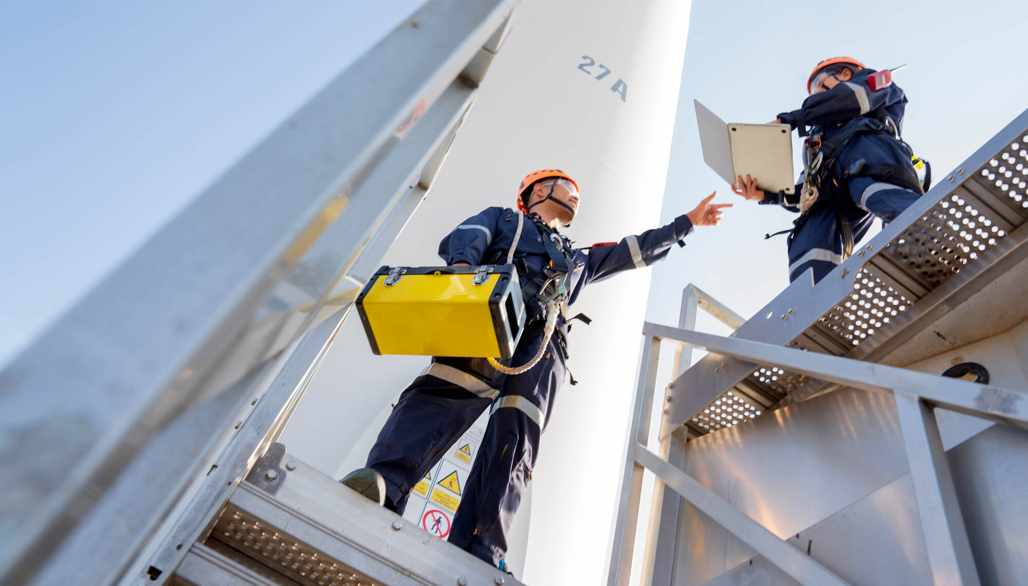 Workers on a platform using laptop